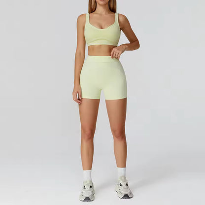 Conjunto de yoga feminino de 2 peças com contraste de cores, composto por sutiã desportivo e leggings de cintura alta, ideal para treino, corrida e fitness.