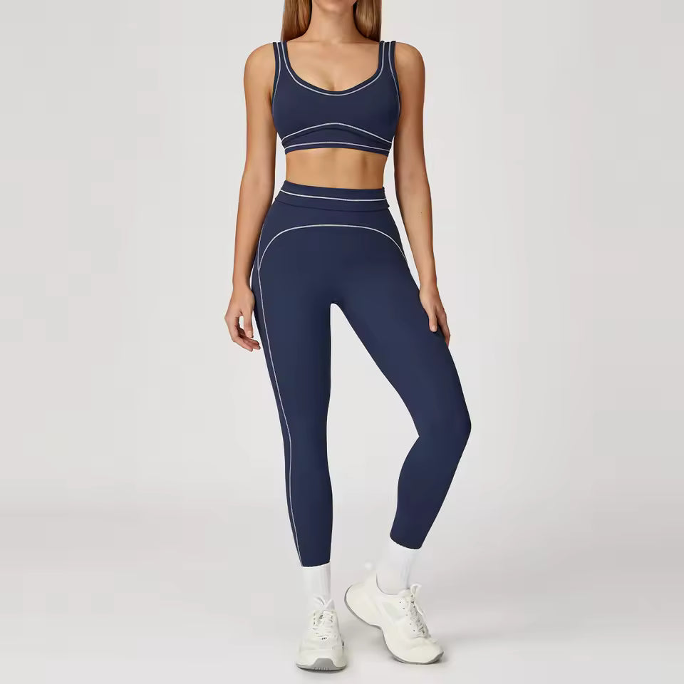 Conjunto de yoga feminino de 2 peças com contraste de cores, composto por sutiã desportivo e leggings de cintura alta, ideal para treino, corrida e fitness.