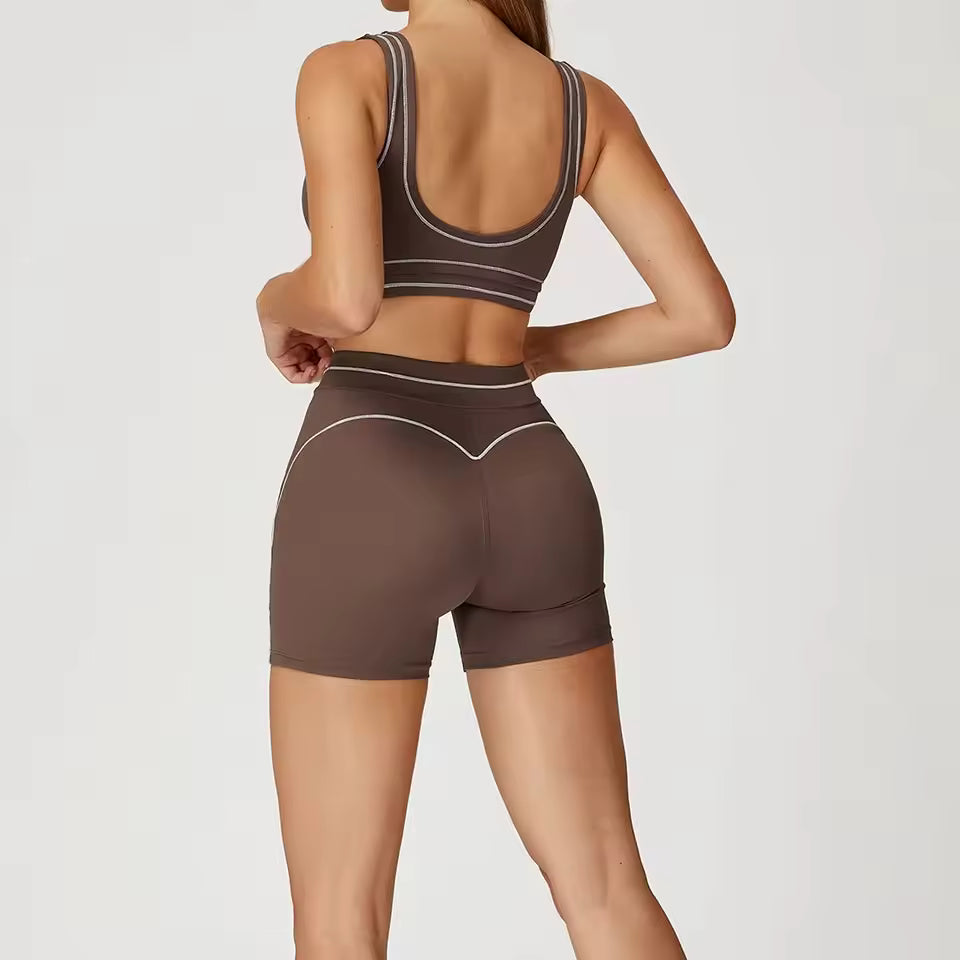Conjunto de yoga feminino de 2 peças com contraste de cores, composto por sutiã desportivo e leggings de cintura alta, ideal para treino, corrida e fitness.