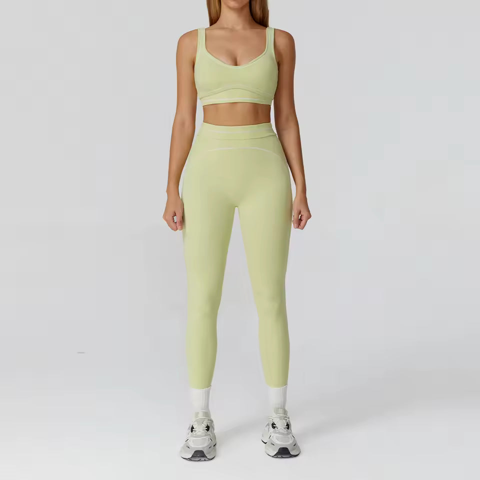 Conjunto de yoga feminino de 2 peças com contraste de cores, composto por sutiã desportivo e leggings de cintura alta, ideal para treino, corrida e fitness.